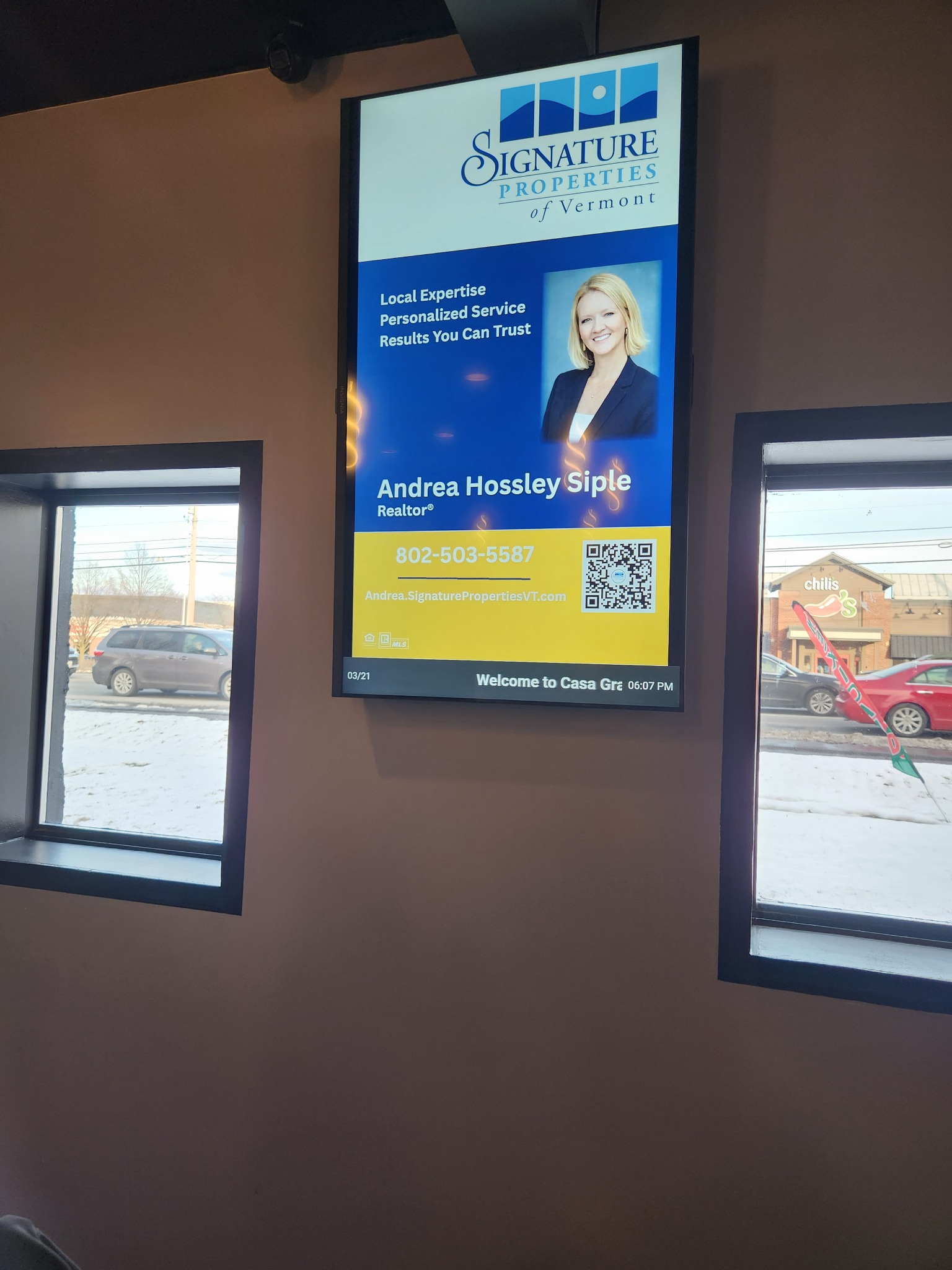 Vertical digital real estate advertisement inside a local venue