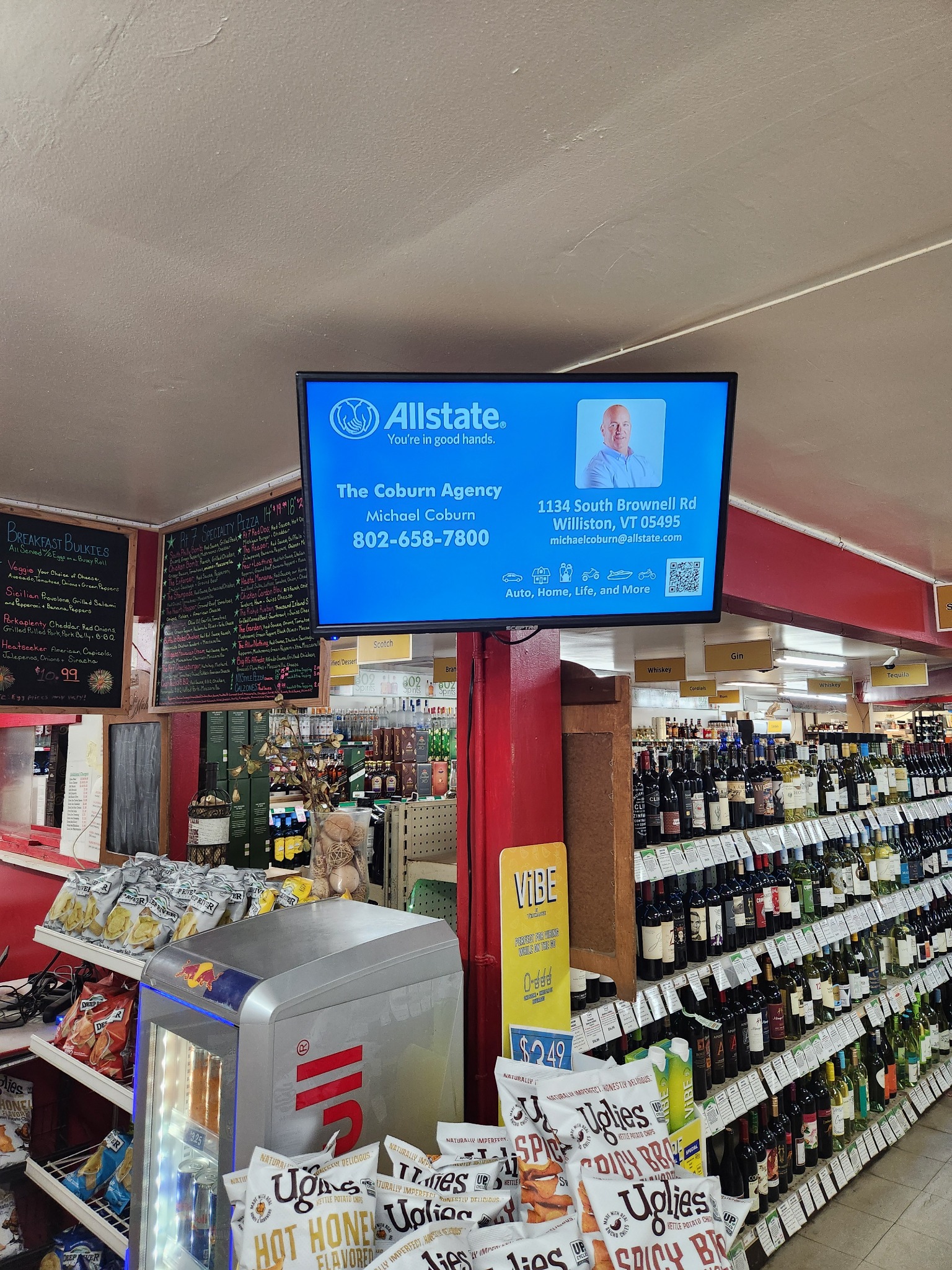Digital insurance advertisement above a market aisle