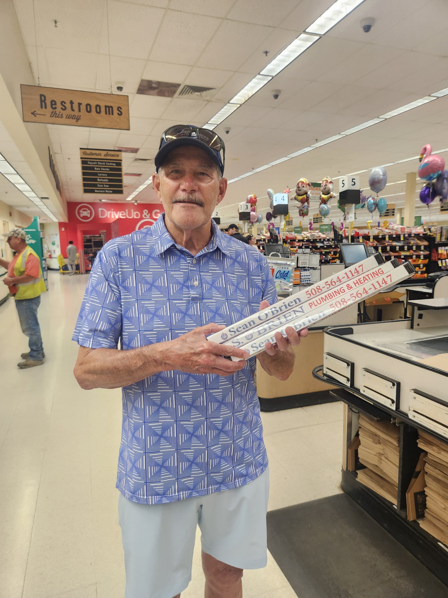 Advertiser holding Sean O'Brien branded checkout dividers