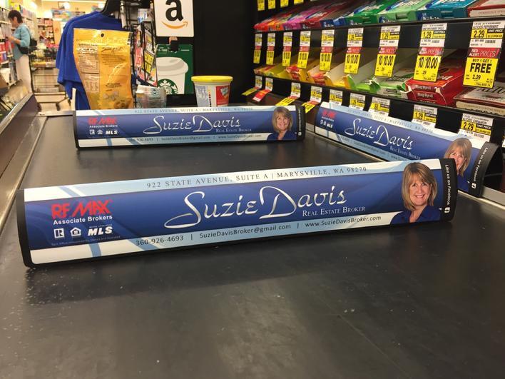 Suzie Davis real estate checkout dividers in a supermarket