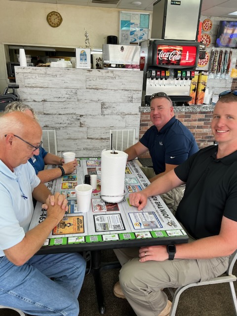 Restaurant patrons seated around an advertising tabletop