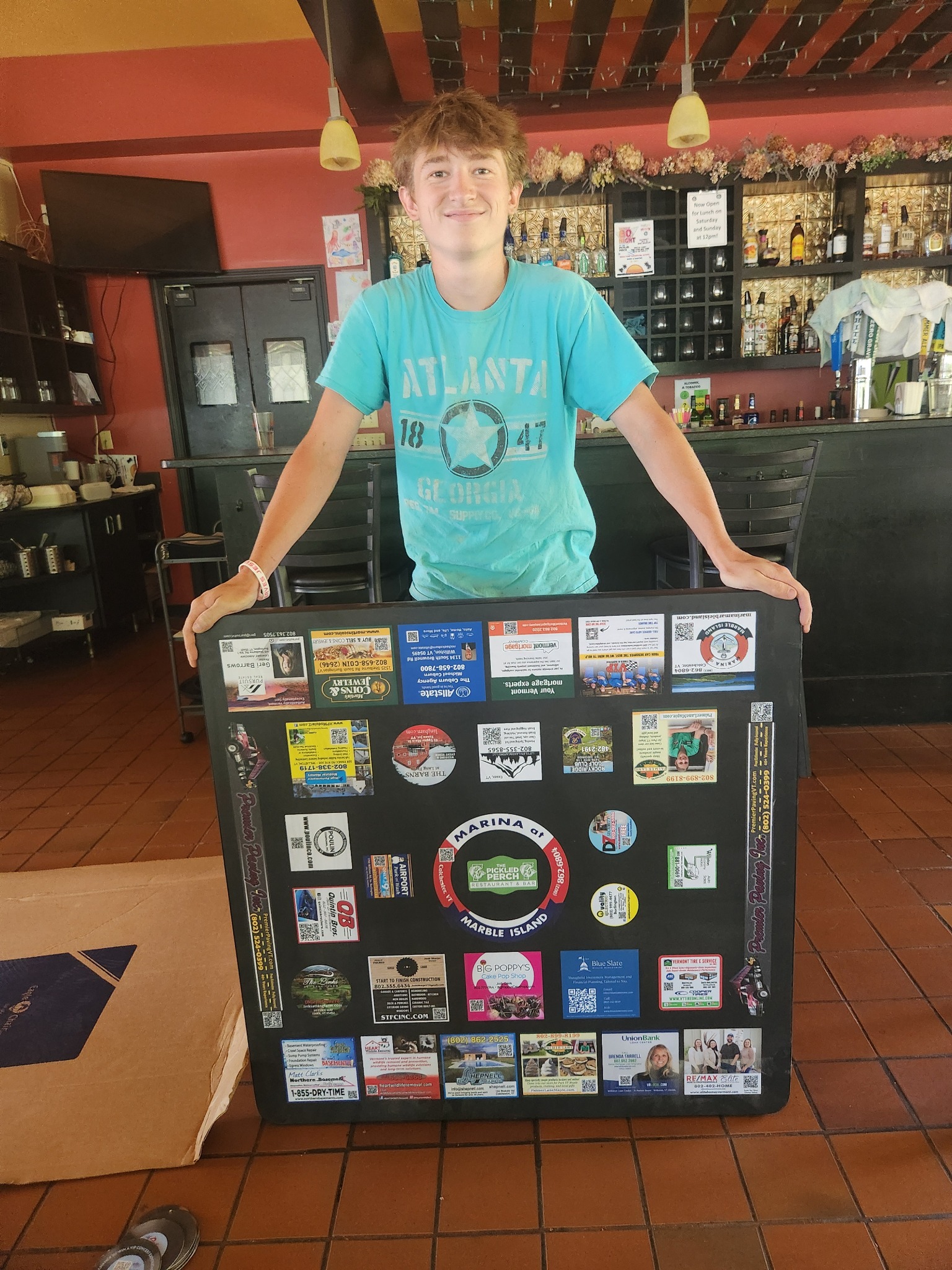 Restaurant team member presenting a completed advertising tabletop